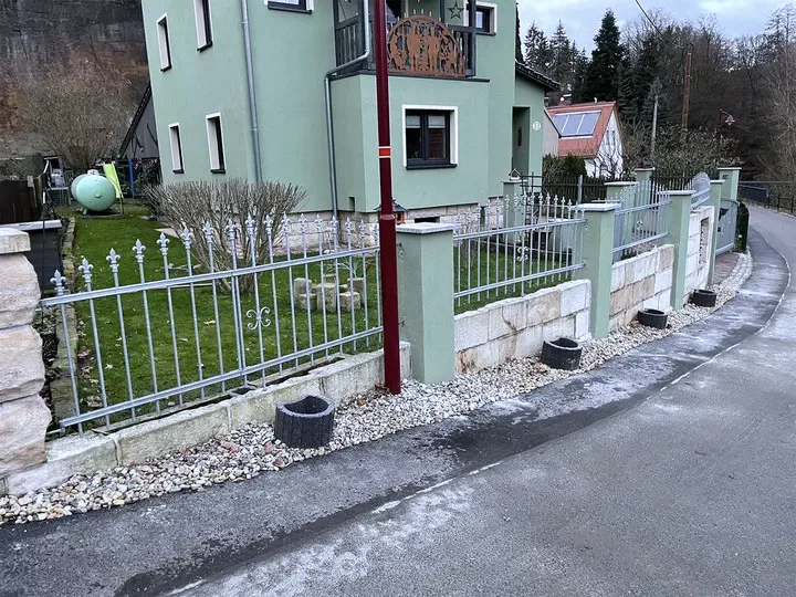 Feuerverzinkte Zaunanlage mit Schiebetor auf einer Natursteinmauer
